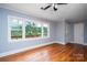 Inviting living room with original hardwood floors and a picturesque window overlooking a backyard and pond at 5100 Crestland Ave, Charlotte, NC 28269