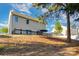 Backyard view featuring a wooden deck with seating, surrounded by lush greenery and mature trees at 532 Dalkeith Ave, Rock Hill, SC 29732
