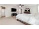 Neutral bedroom with ceiling fan, mounted TV and view to the Primary bathroom at 532 Dalkeith Ave, Rock Hill, SC 29732