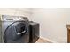 A functional laundry room includes modern front-load washing machine and dryer units with storage shelves at 532 Dalkeith Ave, Rock Hill, SC 29732