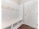 Practical mudroom with white wainscoting, bench seating, and hooks for storage, leading to an exterior door at 532 Dalkeith Ave, Rock Hill, SC 29732