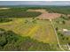 Expansive aerial view of property with sprawling fields, wooded areas and residence with in-ground pool at 5873 Alexis Ln, Vale, NC 28168