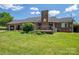 A sprawling green lawn with a brick home featuring a backyard deck and ample space at 5873 Alexis Ln, Vale, NC 28168