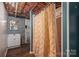 Basement bathroom area with light-colored walls, wood-look flooring, and a stall shower with a patterned curtain at 5873 Alexis Ln, Vale, NC 28168