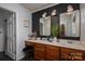 Stylish bathroom with wood paneling, dual sinks, and a charming vanity at 5873 Alexis Ln, Vale, NC 28168