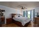 Bright bedroom featuring hardwood floors, a ceiling fan and a large window with a pleasant view at 5873 Alexis Ln, Vale, NC 28168