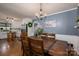 Spacious dining room with hardwood floors, wainscoting, and a modern chandelier at 5873 Alexis Ln, Vale, NC 28168