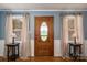 Warm entryway featuring an oval glass front door, side tables, and charming lamps at 5873 Alexis Ln, Vale, NC 28168