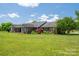 Beautiful brick home showcasing lush landscaping and a well-maintained lawn at 5873 Alexis Ln, Vale, NC 28168