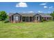Charming brick home featuring well-manicured lawn, bay windows, and welcoming front porch at 5873 Alexis Ln, Vale, NC 28168