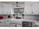 Modern kitchen featuring white cabinets, subway tile backsplash, and stainless steel appliances at 5873 Alexis Ln, Vale, NC 28168