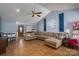 Open living room with vaulted ceilings, fireplace, hardwood floors, and cozy sectional at 5873 Alexis Ln, Vale, NC 28168