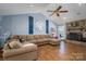 Cozy living room with vaulted ceilings, stone fireplace, and plush sectional sofa at 5873 Alexis Ln, Vale, NC 28168
