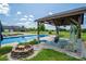 Inviting backyard pool area featuring a shaded patio, fire pit, and lounge chairs at 5873 Alexis Ln, Vale, NC 28168