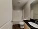 Well-lit bathroom features a modern vanity, toilet, tub and shower combination at 668 Smith St, Kannapolis, NC 28083