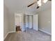 Cozy carpeted bedroom with en-suite bathroom, ceiling fan and neutral color scheme at 668 Smith St, Kannapolis, NC 28083