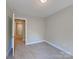 Cozy bedroom featuring neutral carpet and paint with a view to the hallway, providing a blank canvas at 668 Smith St, Kannapolis, NC 28083