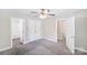 Carpeted bedroom with ample closet space, neutral paint, and ceiling fan at 668 Smith St, Kannapolis, NC 28083