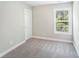 A cozy bedroom with neutral walls, soft carpeting, and a bright window at 668 Smith St, Kannapolis, NC 28083