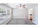 Bright bedroom with plush carpeting, a ceiling fan, and a large window overlooking the landscaped backyard at 668 Smith St, Kannapolis, NC 28083