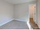 Neutral bedroom with carpet, base molding, and a closet with a standard hinged door at 668 Smith St, Kannapolis, NC 28083