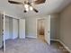 Comfortable carpeted bedroom with closet, ceiling fan, and neutral color scheme at 668 Smith St, Kannapolis, NC 28083