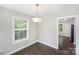 Bright dining room with hardwood floors, neutral paint, and modern light fixture at 668 Smith St, Kannapolis, NC 28083