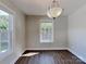 Bright dining room with ample sunlight, modern chandelier, and wood-style flooring at 668 Smith St, Kannapolis, NC 28083
