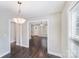 Open-concept dining area with views to front entry way, neutral paint, and wood flooring at 668 Smith St, Kannapolis, NC 28083