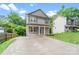 Gray two-story home features a covered porch and an expansive driveway at 668 Smith St, Kannapolis, NC 28083