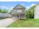 Charming two-story home with gray siding, a covered porch, and a well-manicured front lawn at 668 Smith St, Kannapolis, NC 28083