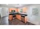 Efficient kitchen featuring stainless steel appliances, granite countertops, and wood cabinets with an exterior door to the backyard at 668 Smith St, Kannapolis, NC 28083