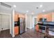 Open kitchen with stainless appliances, maple cabinetry, and attached laundry room at 668 Smith St, Kannapolis, NC 28083