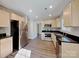 Modern kitchen with stainless steel appliances, stylish wood cabinets, and black countertops at 668 Smith St, Kannapolis, NC 28083