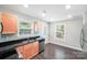 Bright kitchen features stainless steel appliances, granite counter tops, and wood flooring at 668 Smith St, Kannapolis, NC 28083