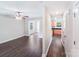 Stylish open concept living area with hardwood flooring, a ceiling fan, and an open doorway to the modern kitchen at 668 Smith St, Kannapolis, NC 28083