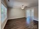 Spacious living room with wood-style flooring, large windows, and contemporary ceiling fan at 668 Smith St, Kannapolis, NC 28083