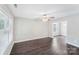 Comfortable living room boasts hardwood flooring, a ceiling fan, and ample natural light from a large window at 668 Smith St, Kannapolis, NC 28083