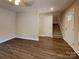 Inviting living room featuring modern wood-style floors, stairway, and neutral wall paint at 668 Smith St, Kannapolis, NC 28083