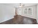Bright living room with hardwood floors, ceiling fan, and staircase, bathed in natural light from a large window at 668 Smith St, Kannapolis, NC 28083