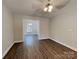 Open living room with wood-style flooring, neutral paint, ceiling fan, and natural light at 668 Smith St, Kannapolis, NC 28083