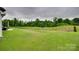 Well-maintained backyard with lush green grass, a manicured lawn, and privacy at 7049 Irongate Dr, Indian Land, SC 29707