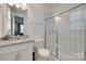 Bathroom features white tiled shower, granite countertop, and modern fixtures at 7049 Irongate Dr, Indian Land, SC 29707