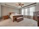 Cozy bedroom with a tray ceiling and natural light at 7049 Irongate Dr, Indian Land, SC 29707