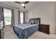 Cozy bedroom featuring wood ceiling fan, plush carpeting and plenty of natural light at 7049 Irongate Dr, Indian Land, SC 29707