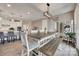 An open dining area features a modern light fixture and connects the kitchen to the rest of the house at 7049 Irongate Dr, Indian Land, SC 29707