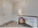 Warm foyer with wood floors, white wainscoting and a decorative table at 7049 Irongate Dr, Indian Land, SC 29707