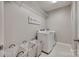 Well-organized laundry room with modern washer/dryer units and ample storage baskets at 7049 Irongate Dr, Indian Land, SC 29707