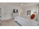 Bright main bedroom featuring neutral tones, a ceiling fan, and an ensuite bath at 7049 Irongate Dr, Indian Land, SC 29707