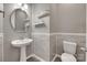 A charming powder room features a pedestal sink and stylish wall paneling at 7049 Irongate Dr, Indian Land, SC 29707